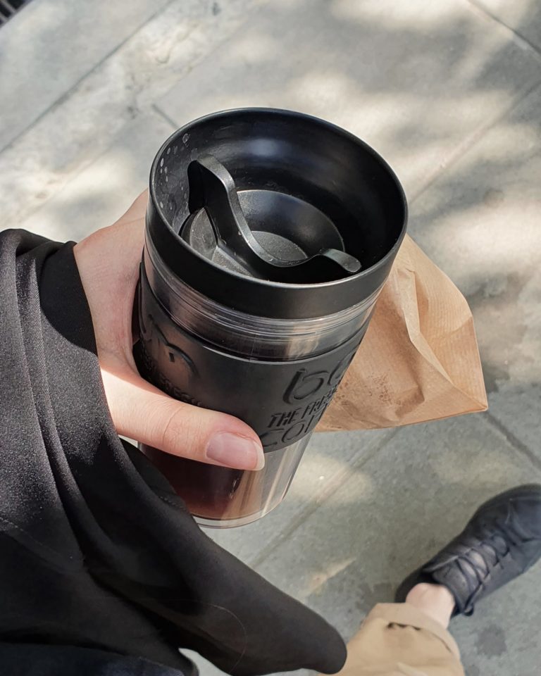walking with reusable coffee cup